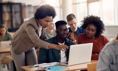 Young professionals collaborating around a laptop